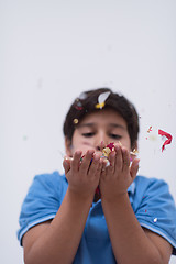 Image showing kid blowing confetti