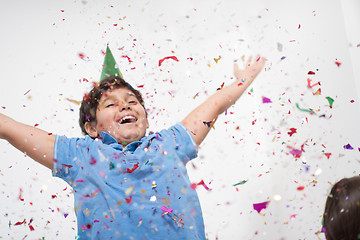 Image showing kid blowing confetti