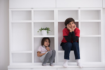 Image showing young boys posing on a shelf