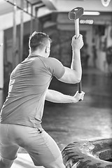 Image showing man workout with hammer and tractor tire