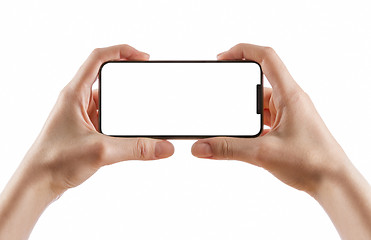 Image showing hands holding black smart phone on white clipping path inside