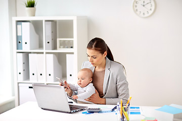 Image showing businesswoman with baby and smartphone at office
