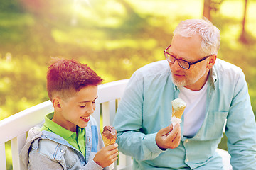 Image showing old man and boy eating ice cream at summer park