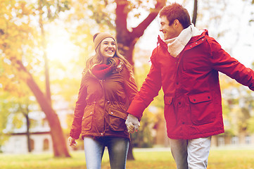 Image showing happy young couple walking in autumn park