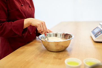 Image showing chef with flour in bowl making batter or dough