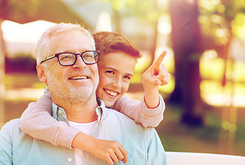 Image showing grandfather and boy pointing finger at summer park