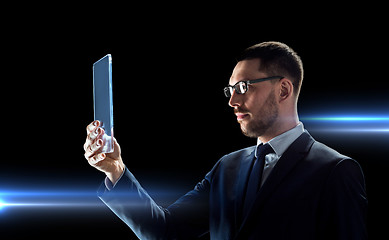 Image showing businessman working with transparent tablet pc