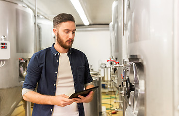 Image showing man with tablet pc at craft brewery or beer plant