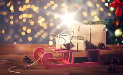 Image showing close up of christmas gift boxes on wooden sleigh