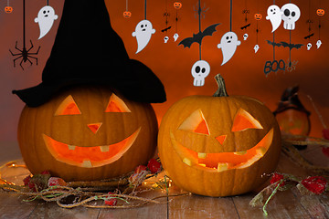 Image showing carved pumpkins in witch hat and halloween garland