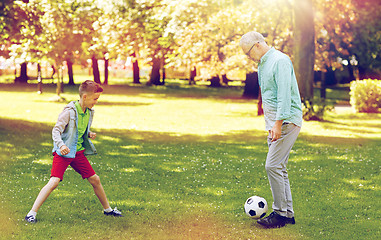 Image showing old man and boy playing football at summer park