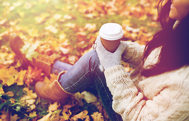 Image showing close up of  woman drinking coffee in autumn park