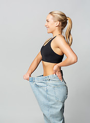 Image showing young slim sporty woman in oversize pants