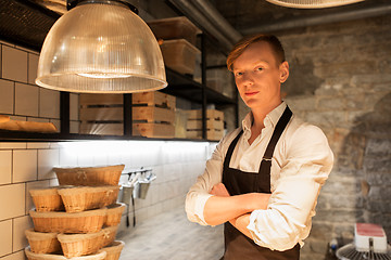 Image showing chef or baker in apron at bakery kitchen