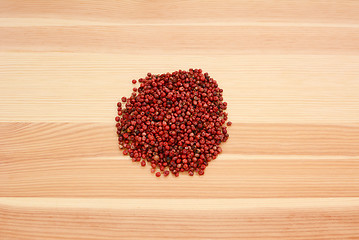 Image showing Pink peppercorns on wood