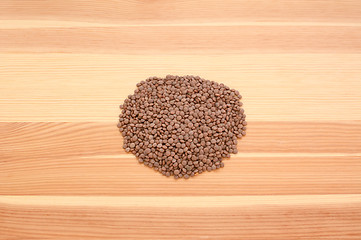 Image showing Brown lentils on wood