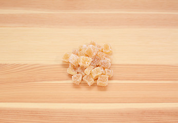 Image showing Cubes of crystallised stem ginger on wood