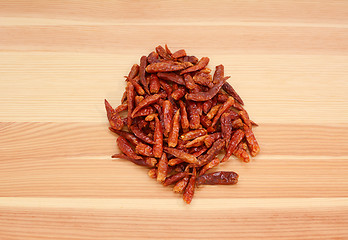 Image showing Birds eye chillis on wood