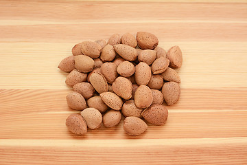 Image showing Almonds in shells on wood