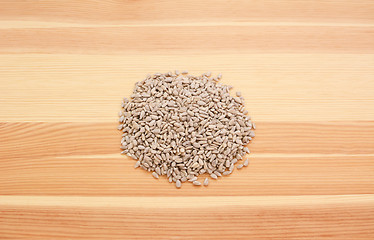 Image showing Hulled sunflower seed hearts on wood