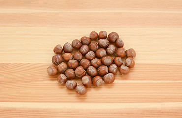 Image showing Hazelnuts in shells on wood