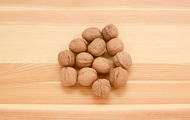 Image showing Walnuts in shells on wood