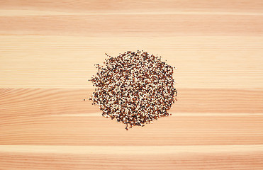 Image showing Mixed red, white and black quinoa on wood