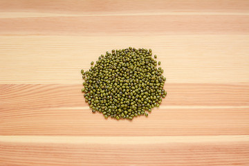 Image showing Dried green mung beans on wood