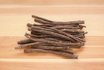 Image showing Pile of liquorice root on wood