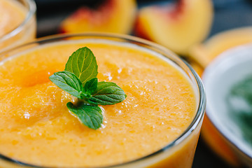 Image showing Orange smoothie with leaves of fresh mint