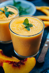 Image showing Orange smoothie with leaves of fresh mint