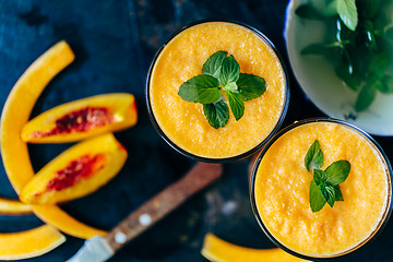 Image showing Orange smoothie with leaves of fresh mint