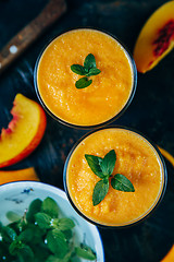 Image showing Orange smoothie with leaves of fresh mint
