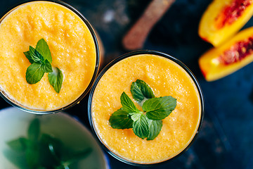 Image showing Orange smoothie with leaves of fresh mint