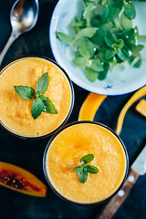 Image showing Orange smoothie with leaves of fresh mint