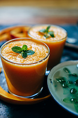 Image showing Orange smoothie with leaves of fresh mint