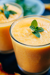 Image showing Orange smoothie with leaves of fresh mint