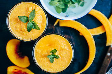 Image showing Orange smoothie with leaves of fresh mint