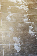 Image showing Foot prints on the tiled floor