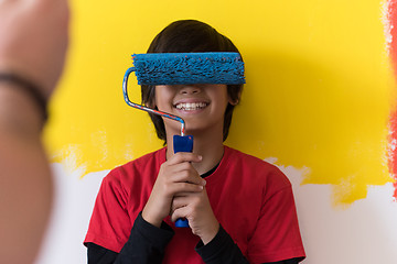 Image showing young boy painter with paint roller