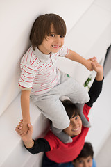 Image showing young boys posing line up piggyback top view