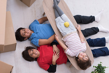 Image showing boys with cardboard boxes around them top view