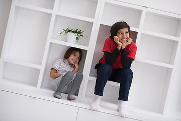 Image showing young boys posing on a shelf