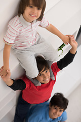 Image showing young boys posing line up piggyback top view