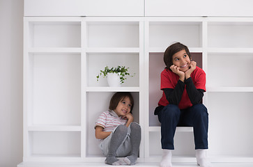 Image showing young boys posing on a shelf