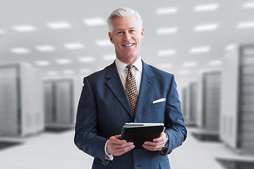 Image showing Senior businessman in server room