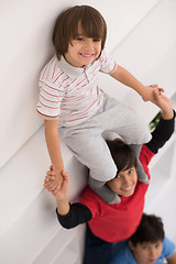 Image showing young boys posing line up piggyback top view