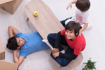 Image showing boys with cardboard boxes around them top view