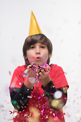 Image showing kid blowing confetti