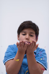 Image showing kid blowing confetti